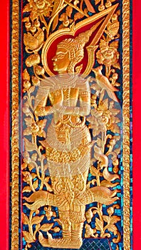 Thai style angel sculpter at temple door in Thailand