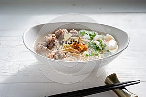 Thai style clear soup rice noodle in traditional bowl. Selective focus