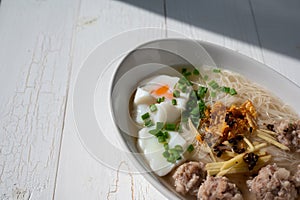 Thai style clear soup rice noodle in traditional bowl. Selective focus