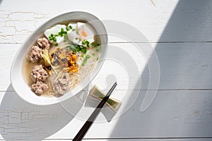 Thai style clear soup rice noodle in traditional bowl. Selective focus