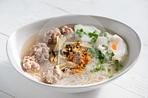 Thai style clear soup rice noodle in traditional bowl. Selective focus