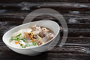 Thai style clear soup rice noodle in traditional bowl. Selective focus