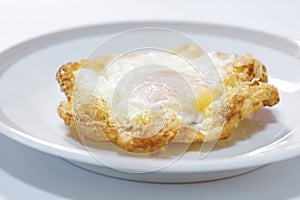 Thai style Deep Fried Egg on plate