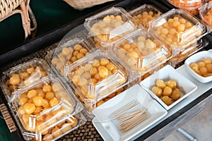 Thai style desserts in plastic boxes.