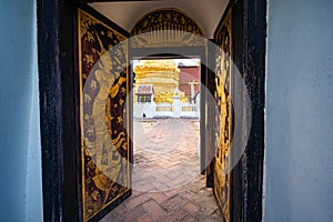 Thai style door frame with golden pagoda in Pong Sanuk temple
