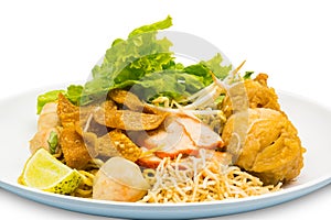 Thai style of dry egg noodle topping with fried chicken drumsti
