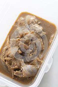 Thai style fermented fish in plastic container