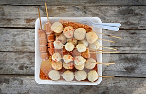 Thai style food of grilled sausage hotdog meat ball and fish ball in stick on tray