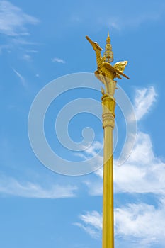 Thai style golden swan statue on golden pillar of public temple