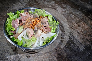 Thai style meat soup in a hotpot with vegetable on wood background