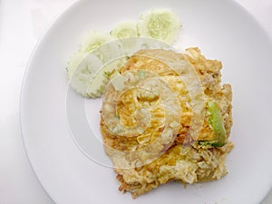 Thai-Style Omelet (Khai Jiao), Omelet with vegetables in white plate, It's popular traditional Thai style food