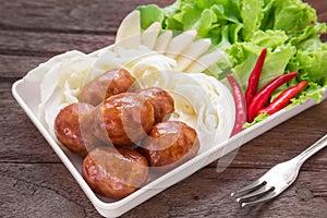 Thai style sausages and fresh vegetables on dish, Thai food