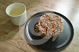 Thai sweet crispy rice cracker with sugar cane baking watermelon juice dressing caramel on plate eat couple hot tea cup