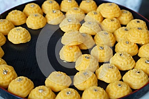Thai sweet dessert, name is Tongeak or Yellow sweetmeats with a piece of gold foil on top, Tha