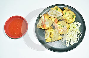 Thai sweetmeat grilled Mortar-toasted pastry seafood  coconut cream hotcake called Kanom Krok dipping chili sauce on plate