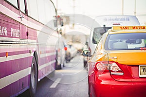 Thai Taxi Meter and Bus drive on street backgroud Red Yellow color