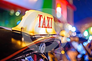 Thai Taxi (Tuk Tuk) sign with defocused lights blur , Chiang Mai