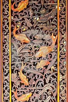 Thai temple door decoration with Golden fish