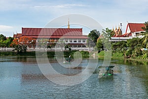 The thai temple near lake with water turbine by solar cell