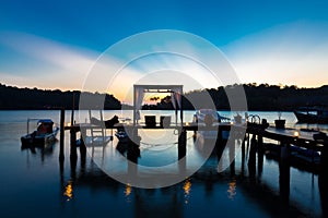 Thai terrace lounges with pergola at sunset on wooden pier in Ko