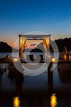 Thai terrace lounges with pergola at sunset on wooden pier in Ko