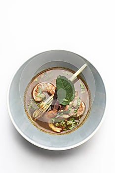 Thai tom yam kung spicy soup with prawns on white background