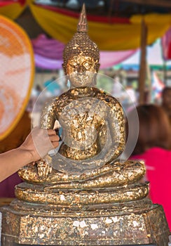Thai tradition cover statue of Buddha with gold leaf and Hands w