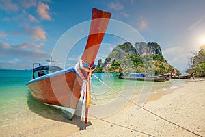 Thai traditional colorful wooden longtail boat and beautiful sand beach in Thailand
