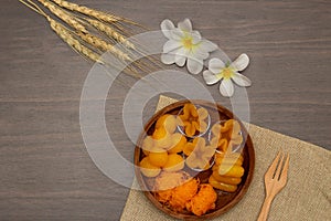 Thai traditional dessert concept, Thong Yip Thong Yod Foi Thong and jackfruit seeds in wood bowl