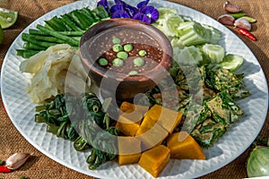 Thai Traditional Food : Spicy Shrimp Paste Dip or Fried shrimp paste sauce Nam Prik Kapi with blanched vegetables and cha-om