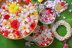 Thai traditional jasmine garland and Colorful flower in water bo