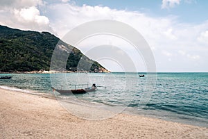 Thai traditional wooden boat and beautiful sand beach. Koh Phangan, Thailand