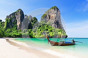 Thai traditional wooden longtail boat and beautiful sand beach