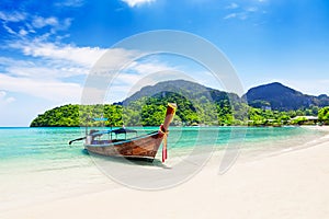 Thai traditional wooden longtail boat and beautiful sand beach