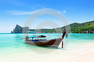 Thai traditional wooden longtail boat and beautiful sand beach at Koh Phi Phi island in Krabi province in Thailand