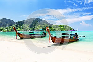 Thai traditional wooden longtail boat and beautiful sand beach at Koh Phi Phi island in Krabi province, Thailand