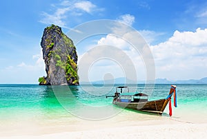 Thai traditional wooden longtail boat and beautiful sand beach at Koh Poda island in Krabi province, Thailand