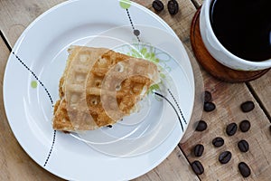Thai waffle on white dish and coffee, Top view.