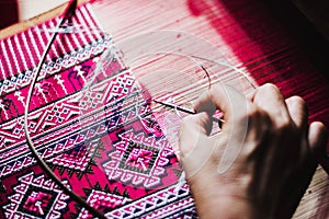 Thai woman making silk thread.