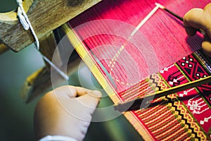 Thai woman making silk thread.