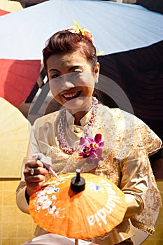 Thai woman paints on umbrellas at BIT 2012