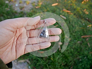 Thai woman show small buddha image amulets in plastic frame