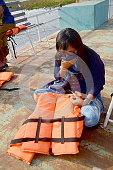Thai woman sit and took the hand-off nose protect smell from air