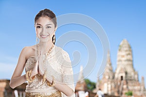 Thai woman in Thai dress costume traditional in a welcome pose