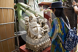 Thai woman visit and respect praying Katyayana or Gautama Buddha