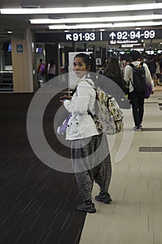 Thai woman walking to gate inside at Narita International Airport