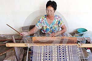 Thai woman weaving straw mat