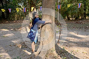 Thai women love and hug tree in garden at Donsawan island