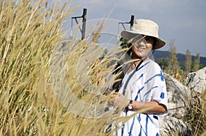 Thai women people travel and posing with stone and Poaceae