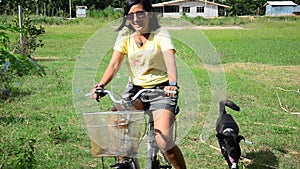 Thai women riding bicycle in the garden